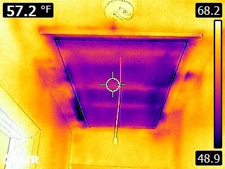 An infrared image of Dennis W.’s attic access hatch (right) shows cold spots and air-infiltration