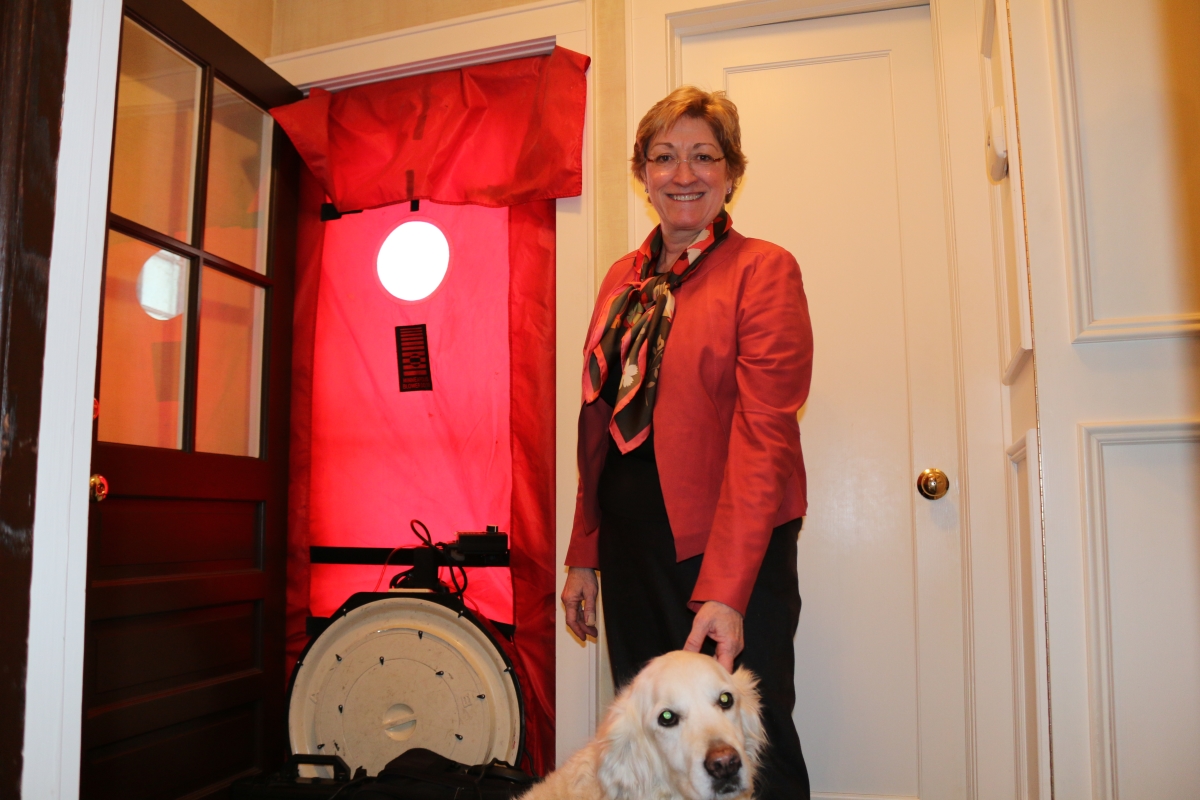 City of Summit Mayor Nora Radest looks on as Ciel measures the air-infiltration of her home.